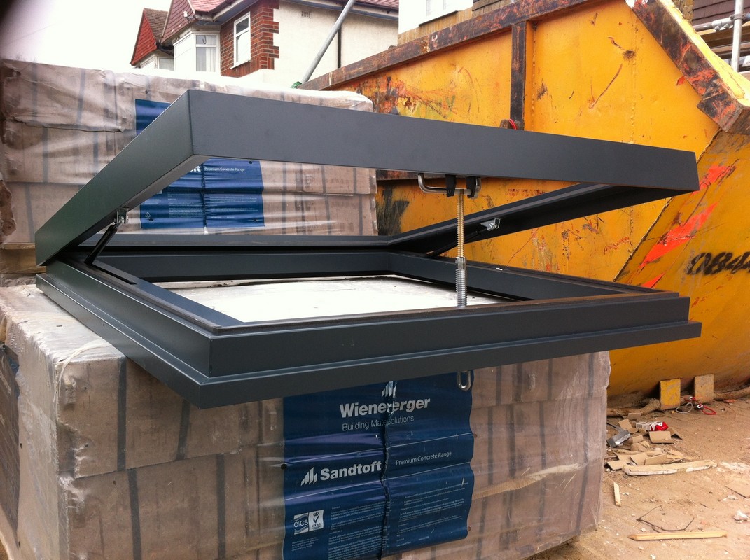 Opening flat roof skylight in anthracite grey installed in Gerrards Cross