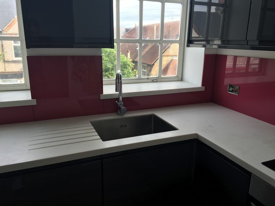 Deep plum coloured glass splashback in modern Gerrards Cross kitchen